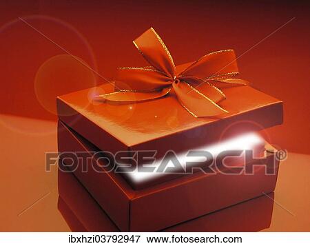 "Red gift box with ribbon, from the gift box emerges a ray of light" View Large Photo Image Stock Photo - "Red gift box with ribbon, from the gift box emerges a ray of light". Fotosearch