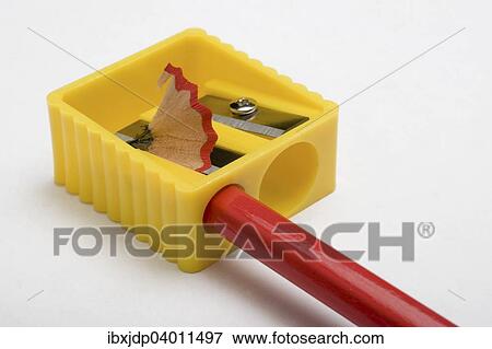 Stock Photo - Red pencil and yellow pencil sharpener. Fotosearch