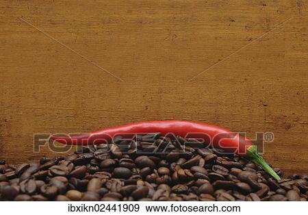 Red pepper on coffee beans View Large Photo Image Stock Photo - Red pepper on coffee beans. Fotosearch