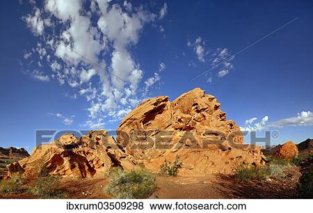 "Red sandstone formation with blue cloudy sky in morning light, on the North Shore Road, Valley of Fire, Nevada, United States, North America" View Large Photo Image Stock Photo - "Red sandstone formation with blue cloudy sky in morning light, on the North Shore Road, Valley of Fire, Nevada, United States, North America". Fotosearch