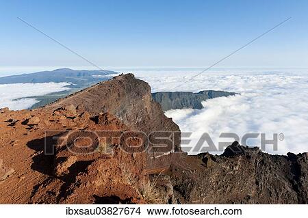 "Red volcanic rock on the summit, Piton des Neiges Mountain, 3069 m, above the clouds, near Cilaos, Reunion" View Large Photo Image Picture - "Red volcanic rock on the summit, Piton des Neiges Mountain, 3069 m, above the clouds, near Cilaos, Reunion". Fotosearch