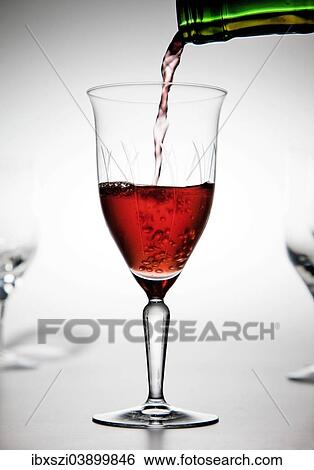 Red wine being poured into a wine glass View Large Photo Image Stock Photograph - Red wine being poured into a wine glass. Fotosearch