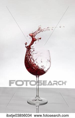 Red wine splashing out of a red wine glass View Large Photo Image Picture - Red wine splashing out of a red wine glass. Fotosearch