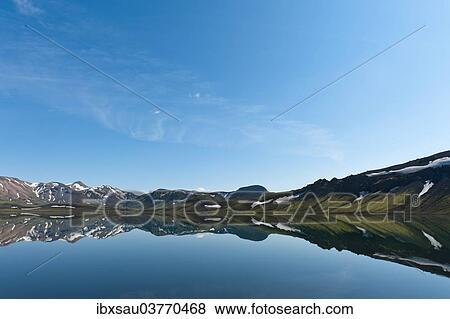 "Reflection in the still lake, remnants of snow, panoramic mountain landscape at Alftavatn lake, Laugavegur trekking route, Highlands, Suourland, Iceland, Europe" View Large Photo Image Stock Photo - "Reflection in the still lake, remnants of snow, panoramic mountain landscape at Alftavatn lake, Laugavegur trekking route, Highlands, Suourland, Iceland, Europe". Fotosearch