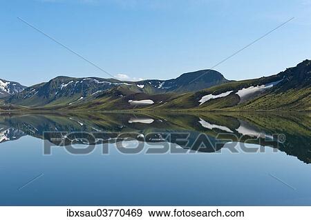 "Reflection in the still lake, remnants of snow, panoramic mountain landscape at Alftavatn lake, Laugavegur trekking route, Highlands, Suourland, Iceland, Europe" View Large Photo Image Stock Photo - "Reflection in the still lake, remnants of snow, panoramic mountain landscape at Alftavatn lake, Laugavegur trekking route, Highlands, Suourland, Iceland, Europe". Fotosearch