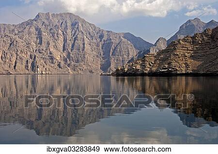 "Reflection of a barren mountain range in the Khor Ash Sham Fjord, on Seebi Island, Musandam Governorate, Oman, Asia" View Large Photo Image Stock Photo - "Reflection of a barren mountain range in the Khor Ash Sham Fjord, on Seebi Island, Musandam Governorate, Oman, Asia". Fotosearch