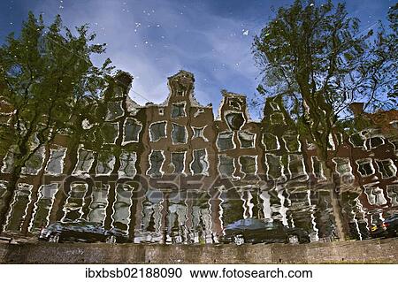 "Reflection of buildings in a canal in Amsterdam, Holland, Netherlands, Europe" View Large Photo Image Stock Image - "Reflection of buildings in a canal in Amsterdam, Holland, Netherlands, Europe". Fotosearch