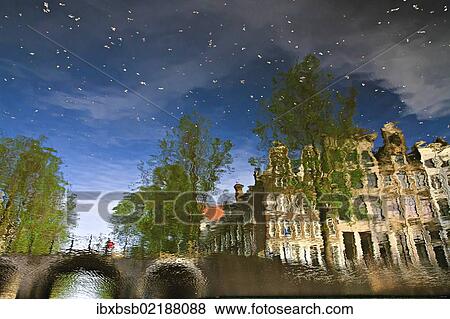 "Reflection of buildings in a canal in Amsterdam, Holland, Netherlands, Europe" View Large Photo Image Stock Photo - "Reflection of buildings in a canal in Amsterdam, Holland, Netherlands, Europe". Fotosearch