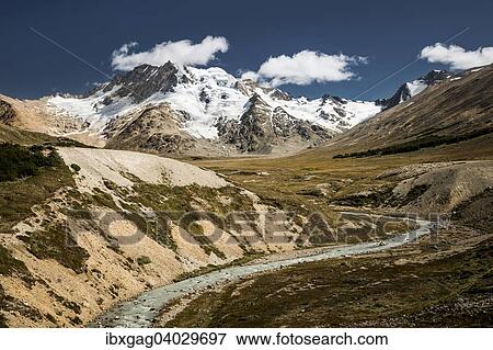 Stock Photo - "River in front of mountains with glaciers, Sierra de las Vacas, Patagonia, Argentina, South America". Fotosearch