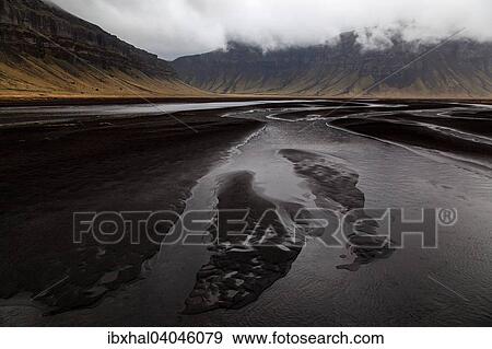 "River landscape, lava sand, mountains, clouds, near Nupsstadur, Iceland, Europe" View Large Photo Image Stock Photo - "River landscape, lava sand, mountains, clouds, near Nupsstadur, Iceland, Europe". Fotosearch