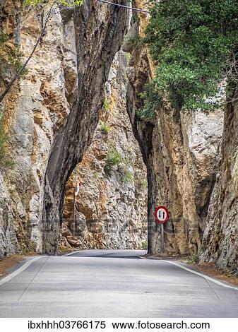 Stock Photography - "Road narrowed as it passes through a rocky gorge, Sa Calobra, Serra de Tramuntana, Majorca, Balearic Islands, Spain, Europe". Fotosearch