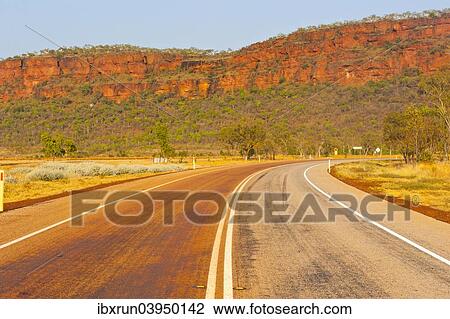 "Road, red cliffs, Northern Territory, Australia, Oceania" View Large Photo Image Stock Image - "Road, red cliffs, Northern Territory, Australia, Oceania". Fotosearch