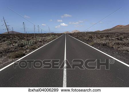 "Road through volcanic landscape, near Mancha Blanca, Lanzarote, Canary Islands, Spain, Europe" View Large Photo Image Stock Photo - "Road through volcanic landscape, near Mancha Blanca, Lanzarote, Canary Islands, Spain, Europe". Fotosearch