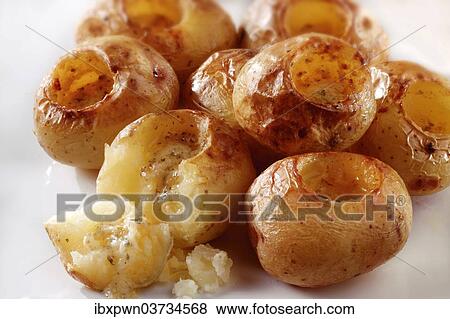 Roast new potatoes with herby butter View Large Photo Image Stock Photo - Roast new potatoes with herby butter. Fotosearch