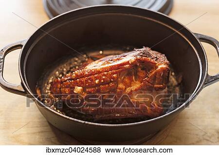 Roast pork with crust in a cast iron casserole View Large Photo Image Stock Photo - Roast pork with crust in a cast iron casserole. Fotosearch