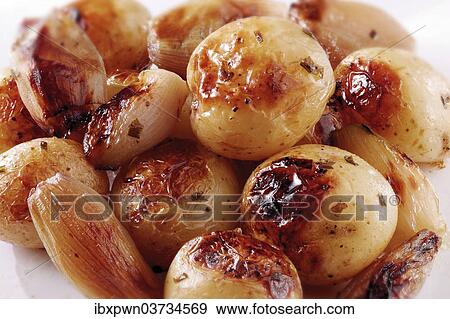 Roast potatoes in their skins and onions View Large Photo Image Stock Photo - Roast potatoes in their skins and onions. Fotosearch