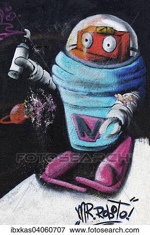 "Robot in a space suit, holding spray can in hand, mural, street art, Duisburg, North Rhine-Westphalia, Germany, Europe" View Large Photo Image Stock Photo - "Robot in a space suit, holding spray can in hand, mural, street art, Duisburg, North Rhine-Westphalia, Germany, Europe". Fotosearch