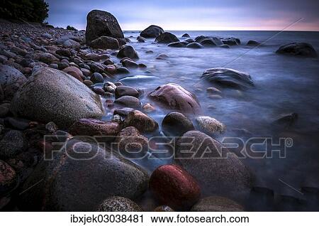 "Rocks on a beach at sunset by the sea, bei Nardewitz, Rugen island, Rugen, Mecklenburg-Western Pomerania, Germany, Europe" View Large Photo Image Stock Image - "Rocks on a beach at sunset by the sea, bei Nardewitz, Rugen island, Rugen, Mecklenburg-Western Pomerania, Germany, Europe". Fotosearch