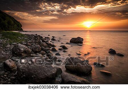 "Rocks on a beach at sunset by the sea, bei Nardewitz, Rugen island, Rugen, Mecklenburg-Western Pomerania, Germany, Europe" View Large Photo Image Stock Photograph - "Rocks on a beach at sunset by the sea, bei Nardewitz, Rugen island, Rugen, Mecklenburg-Western Pomerania, Germany, Europe". Fotosearch