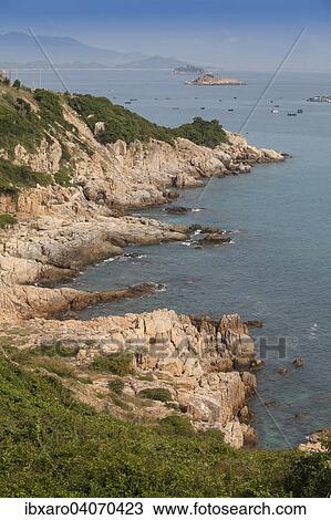 Stock Image - "Rocky cliffs on the Chinese sea, at Phan Rang, Ninh Thuan, Vietnam, Asia". Fotosearch
