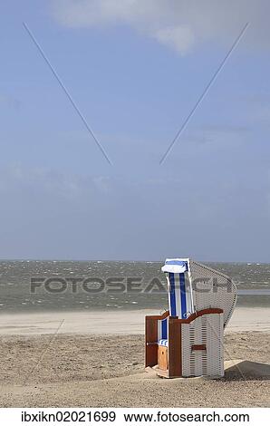 Stock Photo - "Roofed wicker beach chair at the North Sea, Foehr, Schleswig-Holstein, Germany, Europe". Fotosearch
