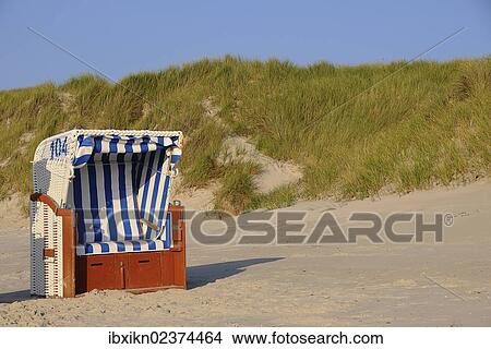 "Roofed wicker beach chair, dunes, North Sea, Amrum, Schleswig-Holstein, Germany, Europe" View Large Photo Image Picture - "Roofed wicker beach chair, dunes, North Sea, Amrum, Schleswig-Holstein, Germany, Europe". Fotosearch