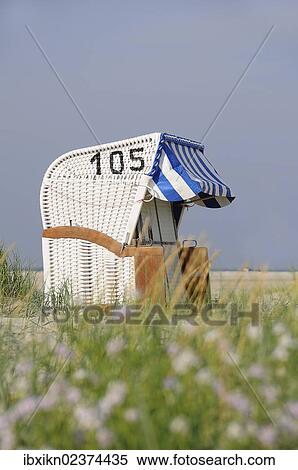 Stock Photography - "Roofed wicker beach chair, North Sea, Amrum, Schleswig-Holstein, Germany, Europe". Fotosearch