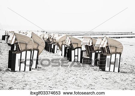 Stock Image - "Roofed wicker beach chairs on the beach, Zingst, Fischland-Darss-Zingst, Mecklenburg-Western Pomerania, Germany, Europe". Fotosearch