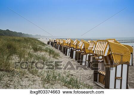 Stock Image - "Roofed wicker beach chairs on the beach, Zingst, Fischland-Darss-Zingst, Mecklenburg-Western Pomerania, Germany, Europe". Fotosearch