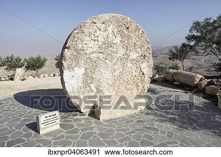 Stock Image - "Round stone, was used as the door of the fortified former Byzantine monastery in the old city of Faisaliyah, formerly known as Kufer Abu Badd, Mount Nebo, near Madaba, Jordan, Asia". Fotosearch