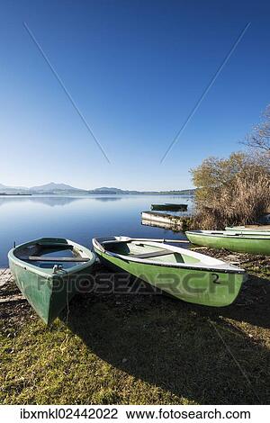 "Rowing boats on the shore of Hopfensee Lake near Fuessen, Ostallgaeu region, Allgaeu, Bavaria, Germany, Europe" View Large Photo Image Stock Image - "Rowing boats on the shore of Hopfensee Lake near Fuessen, Ostallgaeu region, Allgaeu, Bavaria, Germany, Europe". Fotosearch