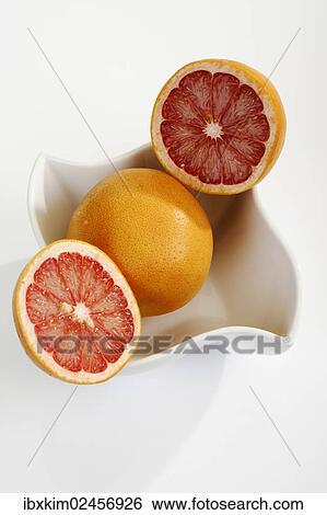 Ruby grapefruit cut open in porcelain bowl View Large Photo Image Stock Photograph - Ruby grapefruit cut open in porcelain bowl. Fotosearch