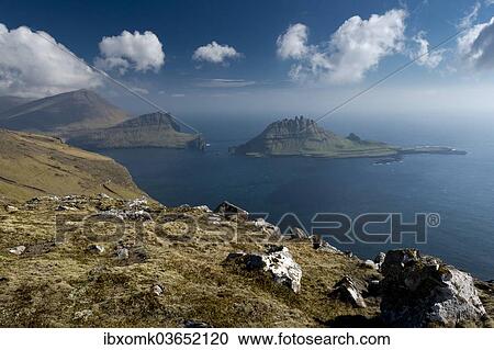 "Rugged rocks of Tindholmur seen from the hiking trail between Bour and Gasadalur, Vagar, Faroe Islands, Denmark, Europe" View Large Photo Image Stock Image - "Rugged rocks of Tindholmur seen from the hiking trail between Bour and Gasadalur, Vagar, Faroe Islands, Denmark, Europe". Fotosearch