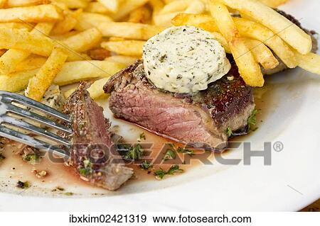 "Rump steak, medium, with French fries and herb butter" View Large Photo Image Stock Photo - "Rump steak, medium, with French fries and herb butter". Fotosearch