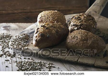 Rye bread rolls on an old bread slide with rye grains View Large Photo Image Stock Photography - Rye bread rolls on an old bread slide with rye grains. Fotosearch