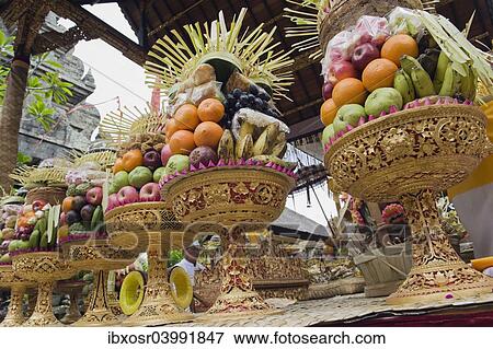 Stock Photo - "Sacrificial offerings, fruit at a temple ceremony, Pura Desa Temple, Ubud, Bali, Indonesia, Asia". Fotosearch
