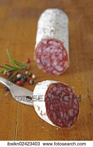 Salami and a slice of salami View Large Photo Image Stock Image - Salami and a slice of salami. Fotosearch