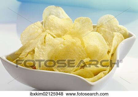 Salted potato chips in a porcelain bowl View Large Photo Image Stock Photo - Salted potato chips in a porcelain bowl. Fotosearch