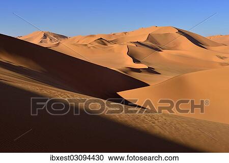 Stock Image - "Sand dunes at Erg Mehejibad, Sahara, Erg Mehejibad, Immidir or Mouydir, Sahara, Tamanrasset Province, Algeria, Africa". Fotosearch