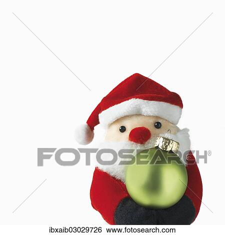 Santa Claus doll holding a Christmas bauble View Large Photo Image Stock Photograph - Santa Claus doll holding a Christmas bauble. Fotosearch