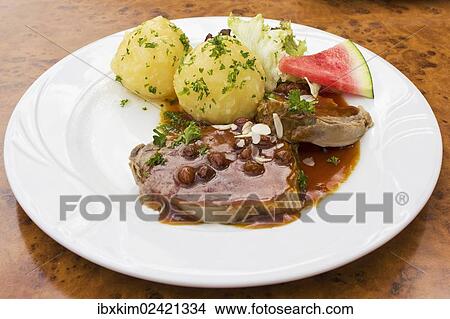 "Sauerbraten, marinated pot roast with potato dumplings" View Large Photo Image Picture - "Sauerbraten, marinated pot roast with potato dumplings". Fotosearch