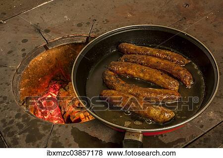 "Sausages frying in a pan on an old wood stove, Middle Franconia, Bavaria, Germany. " View Large Photo Image Stock Photo - "Sausages frying in a pan on an old wood stove, Middle Franconia, Bavaria, Germany. ". Fotosearch