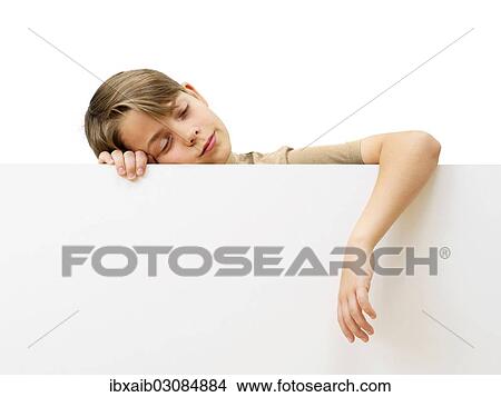 "Schoolboy behind a white board, sleeping" View Large Photo Image Picture - "Schoolboy behind a white board, sleeping". Fotosearch