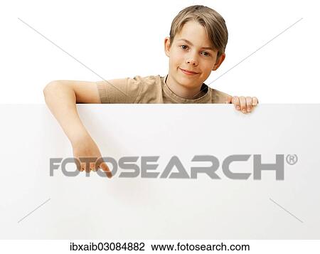 "Schoolboy behind a white board, pointing with his finger, smiling" View Large Photo Image Stock Image - "Schoolboy behind a white board, pointing with his finger, smiling". Fotosearch