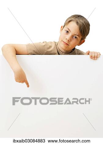 "Schoolboy behind a white board, pointing with his finger, smiling" View Large Photo Image Stock Image - "Schoolboy behind a white board, pointing with his finger, smiling". Fotosearch