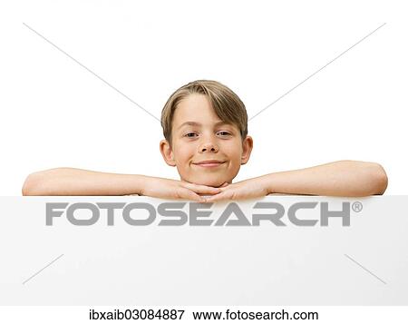 Stock Photo - "Schoolboy behind a white board, grinning". Fotosearch