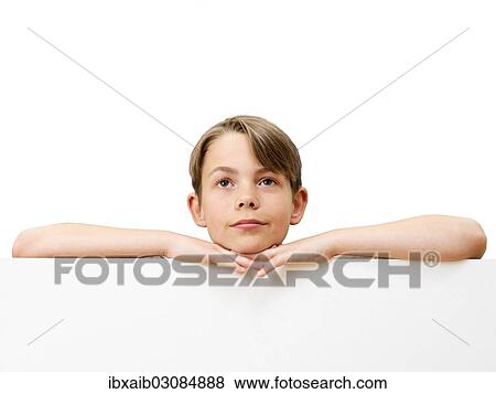 "Schoolboy behind a white board, dreamy, pensive" View Large Photo Image Stock Photo - "Schoolboy behind a white board, dreamy, pensive". Fotosearch