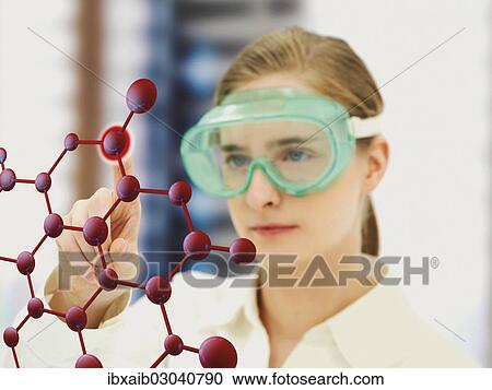 Stock Image - Scientist pointing to a molecule model. Fotosearch