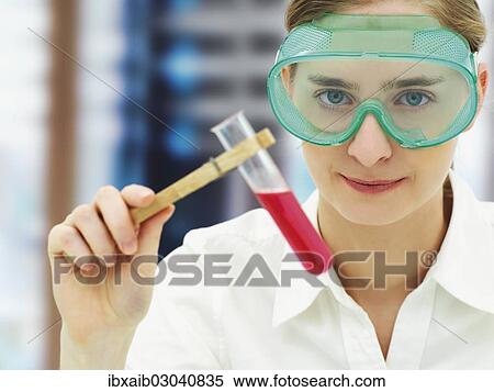 Scientist wearing a protective mask and holding a test tube View Large Photo Image Stock Photography - Scientist wearing a protective mask and holding a test tube. Fotosearch