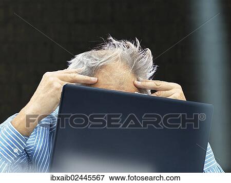 "Senior, behind a laptop with a stressed expression" View Large Photo Image Stock Photo - "Senior, behind a laptop with a stressed expression". Fotosearch